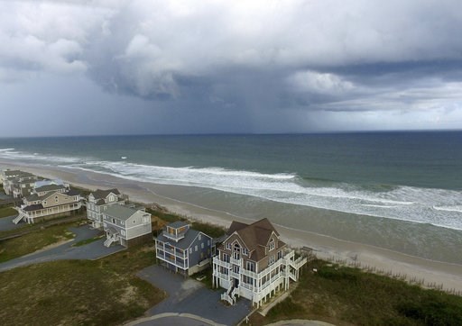 (AP Photo/Tom Copeland). A storm front passes homes in North Topsail Beach, N.C., prior to Hurricane Florence moving toward the east coast on Wednesday, Sept. 12, 2018. (AP Photo/Tom Copeland). A storm front passes homes in North Topsail Beach, N.C., prior to Hurricane Florence moving toward the east coast on Wednesday, Sept. 12, 2018.