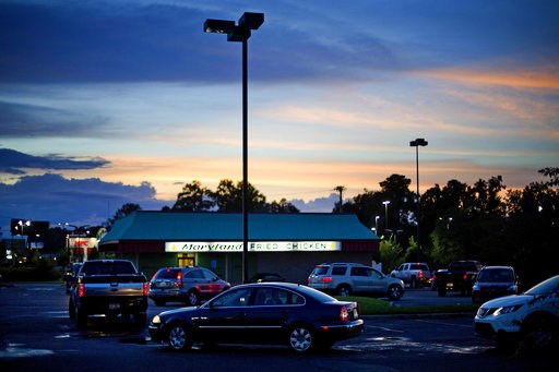 (AP Photo/David Goldman). Cars line up in the drive thru for one of the few food establishments to remain open in Conway, S.C., Wednesday, Sept. 12, 2018, as Hurricane Florence approaches the east coast. (AP Photo/David Goldman). Cars line up in the drive thru for one of the few food establishments to remain open in Conway, S.C., Wednesday, Sept. 12, 2018, as Hurricane Florence approaches the east coast.