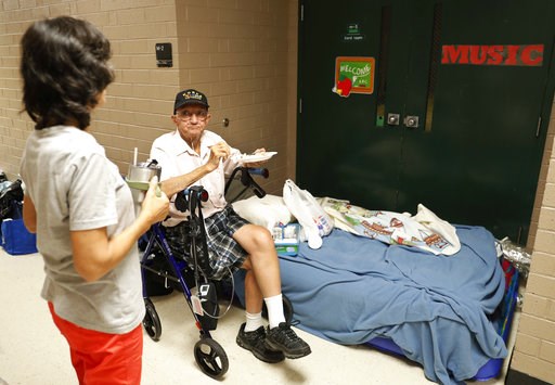 (AP Photo/David Goldman). Mary Edsall, 55, left, talks with her father, Korean war veteran Ed Coddington, 83, while waiting in a shelter for Hurricane Florence to pass after evacuating from Coddington's nearby home in Conway, S.C., Wednesday, Sept. 12,... (AP Photo/David Goldman). Mary Edsall, 55, left, talks with her father, Korean war veteran Ed Coddington, 83, while waiting in a shelter for Hurricane Florence to pass after evacuating from Coddington's nearby home in Conway, S.C., Wednesday, Sept. 12,...