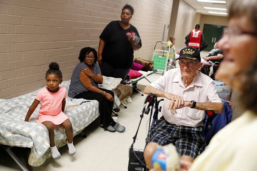 (AP Photo/David Goldman). Korea war veteran, Ed Coddington, 83, second from right, and wife Esther, 78, wait with Markia McCleod, rear, her aunt Ernestine McCleod and daughter Keymoni, 4, in a shelter for Hurricane Florence to pass after evacuating fro... (AP Photo/David Goldman). Korea war veteran, Ed Coddington, 83, second from right, and wife Esther, 78, wait with Markia McCleod, rear, her aunt Ernestine McCleod and daughter Keymoni, 4, in a shelter for Hurricane Florence to pass after evacuating fro...