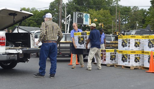 (Janet S. Carter/Daily Free Press via AP). Allen Cahoon and Toby Bryant load a generators for a customer Thursday, Sept. 13, 2018 at Big Blue Store in Kinston NC.. (Janet S. Carter/Daily Free Press via AP). Allen Cahoon and Toby Bryant load a generators for a customer Thursday, Sept. 13, 2018 at Big Blue Store in Kinston NC..