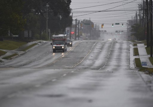 (Matt Born/The Star-News via AP). A few cars drive along an almost deserted Market St. in Wilmington, N.C., Thursday, Sept. 13, 2018. Florence's outer bands of wind and rain began lashing North Carolina on Thursday. (Matt Born/The Star-News via AP). A few cars drive along an almost deserted Market St. in Wilmington, N.C., Thursday, Sept. 13, 2018. Florence's outer bands of wind and rain began lashing North Carolina on Thursday.