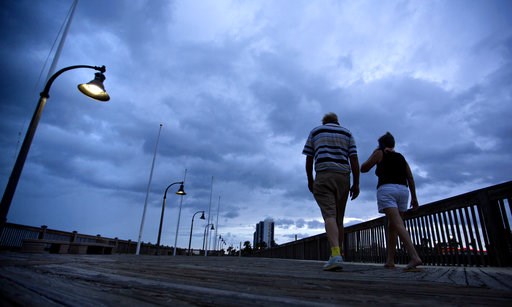 (AP Photo/David Goldman). A couple walks along the boardwalk as Hurricane Florence approaches Myrtle Beach, S.C., Thursday, Sept. 13, 2018. (AP Photo/David Goldman). A couple walks along the boardwalk as Hurricane Florence approaches Myrtle Beach, S.C., Thursday, Sept. 13, 2018.