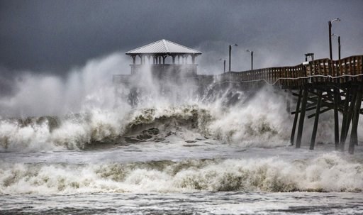 (Travis Long/The News & Observer via AP). Waves slam the Oceana Pier & Pier House Restaurant in Atlantic Beach, N.C., Thursday, Sept. 13, 2018 as Hurricane Florence approaches the area. (Travis Long/The News & Observer via AP). Waves slam the Oceana Pier & Pier House Restaurant in Atlantic Beach, N.C., Thursday, Sept. 13, 2018 as Hurricane Florence approaches the area.