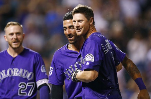 (AP Photo/David Zalubowski). Colorado Rockies' DJ LeMahieu, right, is congratulated after hitting a two-run home run by Ian Desmond, center, and Trevor Story to defeat the Arizona Diamondbacks in the ninth inning of a baseball game, Wednesday, Sept. 12... (AP Photo/David Zalubowski). Colorado Rockies' DJ LeMahieu, right, is congratulated after hitting a two-run home run by Ian Desmond, center, and Trevor Story to defeat the Arizona Diamondbacks in the ninth inning of a baseball game, Wednesday, Sept. 12...
