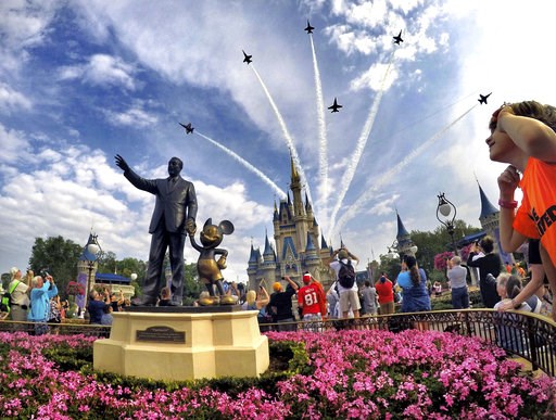 (Joe Burbank/Orlando Sentinel via AP, File). FILE- In this April 16, 2017 file photo, the Blue Angels, the U.S. Navy's legendary flight performance squadron, fly in formation over Cinderella Castle and the 'Partners' statue at the Magic Kingdom at Walt... (Joe Burbank/Orlando Sentinel via AP, File). FILE- In this April 16, 2017 file photo, the Blue Angels, the U.S. Navy's legendary flight performance squadron, fly in formation over Cinderella Castle and the 'Partners' statue at the Magic Kingdom at Walt...