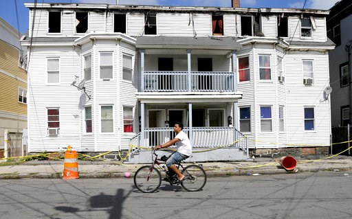 (AP Photo/Mary Schwalm). A man on a bicycle rides past a house destroyed by fire on Springfield St in Lawrence, Mass., Friday, Sept. 14, 2018. Multiple houses were damaged Thursday afternoon from gas explosions and fires triggered by a problem with a g... (AP Photo/Mary Schwalm). A man on a bicycle rides past a house destroyed by fire on Springfield St in Lawrence, Mass., Friday, Sept. 14, 2018. Multiple houses were damaged Thursday afternoon from gas explosions and fires triggered by a problem with a g...