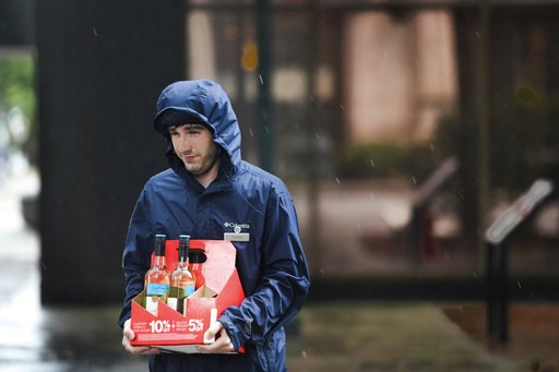 (AP Photo/Sean Rayford). A young man carries bottles of wine down the sidewalk as the remnants of Hurricane Florence slowly move across the East Coast Saturday, Sept. 15, 2018, in Columbia, S.C. (AP Photo/Sean Rayford). A young man carries bottles of wine down the sidewalk as the remnants of Hurricane Florence slowly move across the East Coast Saturday, Sept. 15, 2018, in Columbia, S.C.
