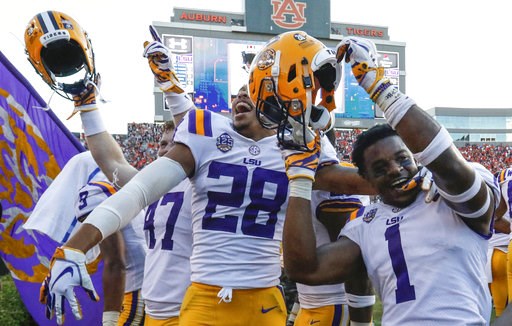 (AP Photo/Butch Dill). LSU players celebrate after they defeated Auburn on a last second field goal during the second half of an NCAA college football game, Saturday, Sept. 15, 2018, in Auburn, Ala. LSU won 22-21. (AP Photo/Butch Dill). LSU players celebrate after they defeated Auburn on a last second field goal during the second half of an NCAA college football game, Saturday, Sept. 15, 2018, in Auburn, Ala. LSU won 22-21.