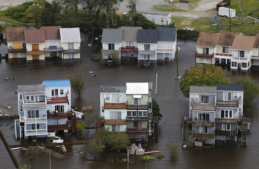 The Latest: Child swept away by floodwaters