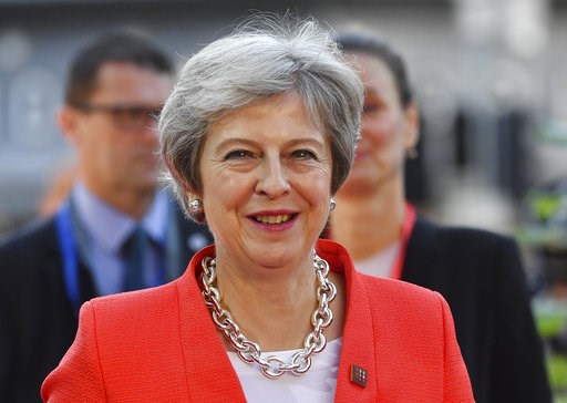 The Latest: Pound falls after May says Brexit at 'impasse'