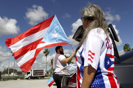 Hundreds mark Hurricane Maria anniversary near Trump resort