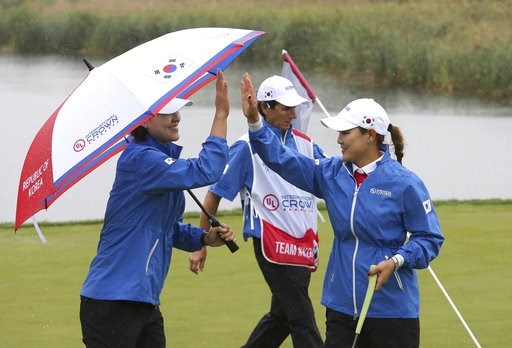 (AP Photo/Ahn Young-joon). In Gee Chun, left, of South Korea reacts with her teammate So Yeon Ryu on the fourth hole during the second round of the LPGA's UL International Crown golf tournament at the Jack Nicklaus Golf Club Korea in Incheon, South Kor... (AP Photo/Ahn Young-joon). In Gee Chun, left, of South Korea reacts with her teammate So Yeon Ryu on the fourth hole during the second round of the LPGA's UL International Crown golf tournament at the Jack Nicklaus Golf Club Korea in Incheon, South Kor...