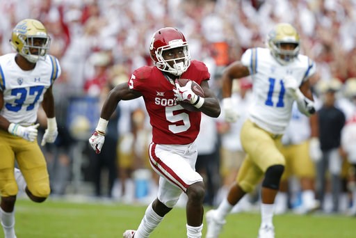 (AP Photo/Sue Ogrocki, File). FILE - In this Sept. 8, 2018, file photo, Oklahoma wide receiver Marquise Brown (5) runs away from UCLA defensive back Quentin Lake (37) and linebacker Keisean Lucier-South (11) for a touchdown in the first quarter of an N... (AP Photo/Sue Ogrocki, File). FILE - In this Sept. 8, 2018, file photo, Oklahoma wide receiver Marquise Brown (5) runs away from UCLA defensive back Quentin Lake (37) and linebacker Keisean Lucier-South (11) for a touchdown in the first quarter of an N...