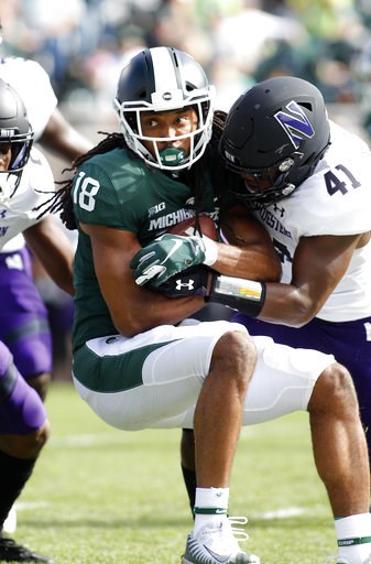 (AP Photo/Al Goldis). Michigan State's Felton Davis (18) is stopped by Northwestern's Jared McGee (41) during the first quarter of an NCAA college football game, Saturday, Oct. 6, 2018, in East Lansing, Mich. (AP Photo/Al Goldis). Michigan State's Felton Davis (18) is stopped by Northwestern's Jared McGee (41) during the first quarter of an NCAA college football game, Saturday, Oct. 6, 2018, in East Lansing, Mich.