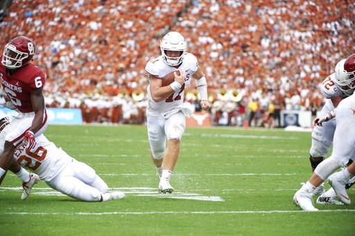 (AP Photo/Cooper Neill). Texas quarterback Sam Ehlinger (11) scrambles for a 9-yard touchdown against Oklahoma during the first half of an NCAA college football game at the Cotton Bowl, Saturday, Oct. 6, 2018, in Dallas. (AP Photo/Cooper Neill). Texas quarterback Sam Ehlinger (11) scrambles for a 9-yard touchdown against Oklahoma during the first half of an NCAA college football game at the Cotton Bowl, Saturday, Oct. 6, 2018, in Dallas.