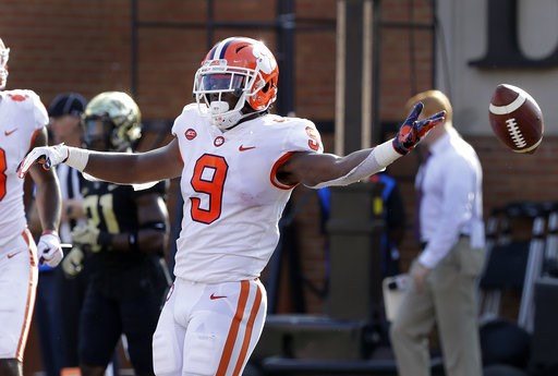 (AP Photo/Chuck Burton). Clemson's Travis Etienne (9) celebrates his touchdown run against Wake Forest during the first half of an NCAA college football game in Charlotte, N.C., Saturday, Oct. 6, 2018. (AP Photo/Chuck Burton). Clemson's Travis Etienne (9) celebrates his touchdown run against Wake Forest during the first half of an NCAA college football game in Charlotte, N.C., Saturday, Oct. 6, 2018.
