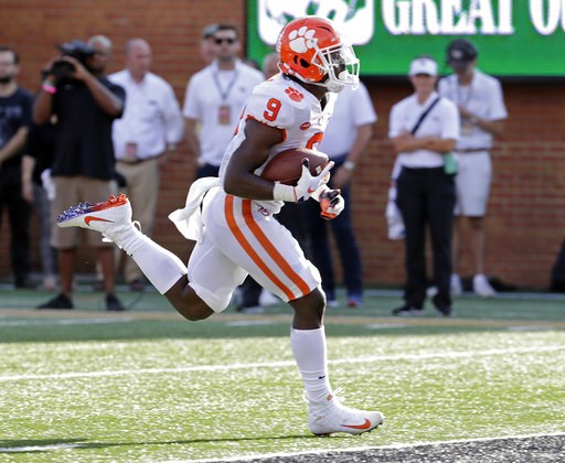 (AP Photo/Chuck Burton). Clemson's Travis Etienne (9) runs for a touchdown against Wake Forest during the first half of an NCAA college football game in Charlotte, N.C., Saturday, Oct. 6, 2018. (AP Photo/Chuck Burton). Clemson's Travis Etienne (9) runs for a touchdown against Wake Forest during the first half of an NCAA college football game in Charlotte, N.C., Saturday, Oct. 6, 2018.