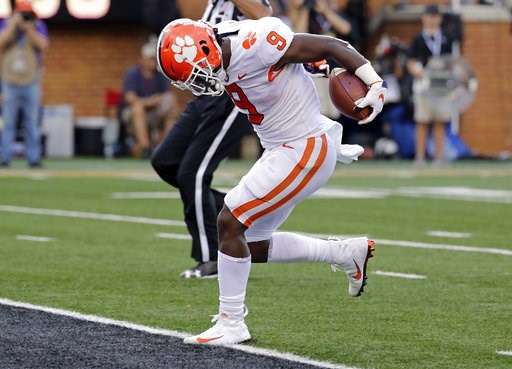 (AP Photo/Chuck Burton). Clemson's Travis Etienne (9) runs for a touchdown against Wake Forest during the first half of an NCAA college football game in Charlotte, N.C., Saturday, Oct. 6, 2018. (AP Photo/Chuck Burton). Clemson's Travis Etienne (9) runs for a touchdown against Wake Forest during the first half of an NCAA college football game in Charlotte, N.C., Saturday, Oct. 6, 2018.