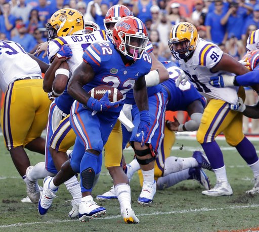 (AP Photo/John Raoux). Florida running back Lamical Perine (22) runs past the LSU defense for a 1-yard touchdown during the first half of an NCAA college football game, Saturday, Oct. 6, 2018, in Gainesville, Fla. (AP Photo/John Raoux). Florida running back Lamical Perine (22) runs past the LSU defense for a 1-yard touchdown during the first half of an NCAA college football game, Saturday, Oct. 6, 2018, in Gainesville, Fla.
