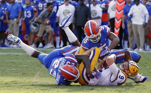 (AP Photo/John Raoux). LSU quarterback Joe Burrow (9) is tackled by Florida defensive back Chauncey Gardner-Johnson (23) and defensive back CJ Henderson, right, after running for a first down during the first half of an NCAA college football game, Satu... (AP Photo/John Raoux). LSU quarterback Joe Burrow (9) is tackled by Florida defensive back Chauncey Gardner-Johnson (23) and defensive back CJ Henderson, right, after running for a first down during the first half of an NCAA college football game, Satu...