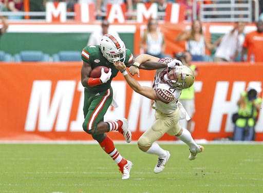 (David Santiago/Miami Herald via AP). Florida State punter Logan Tyler, right, grabs Miami wide receiver Jeff Thomas by the mask during the first half of an NCAA college football game, Saturday, Oct. 6, 2018, in Miami Gardens, Fla. (David Santiago/Miami Herald via AP). Florida State punter Logan Tyler, right, grabs Miami wide receiver Jeff Thomas by the mask during the first half of an NCAA college football game, Saturday, Oct. 6, 2018, in Miami Gardens, Fla.