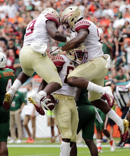 (AP Photo/Lynne Sladky). Florida State wide receiver Keith Gavin, center, celebrates with running back Jacques Patrick (9) and tight end Tre' McKitty, right, after scoring a touchdown during the first half of an NCAA college football game against Miami... (AP Photo/Lynne Sladky). Florida State wide receiver Keith Gavin, center, celebrates with running back Jacques Patrick (9) and tight end Tre' McKitty, right, after scoring a touchdown during the first half of an NCAA college football game against Miami...