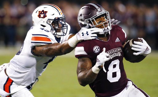 (AP Photo/Rogelio V. Solis). Mississippi State running back Kylin Hill (8) breaks away from a attempted tackle by Auburn linebacker Darrell Williams (49) as he runs for a first down during the first half of their NCAA college football game in Starkvill... (AP Photo/Rogelio V. Solis). Mississippi State running back Kylin Hill (8) breaks away from a attempted tackle by Auburn linebacker Darrell Williams (49) as he runs for a first down during the first half of their NCAA college football game in Starkvill...