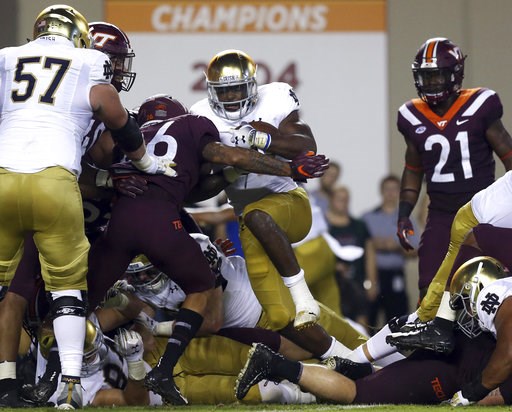 (Matt Gentry/The Roanoke Times via AP). Notre Dame's Dexter Williams (2) fights his way into the end zone for a touchdown against Virginia Tech during the first half of an NCAA college football game Saturday, Oct. 6, 2018, in Blacksburg, Va. (Matt Gentry/The Roanoke Times via AP). Notre Dame's Dexter Williams (2) fights his way into the end zone for a touchdown against Virginia Tech during the first half of an NCAA college football game Saturday, Oct. 6, 2018, in Blacksburg, Va.