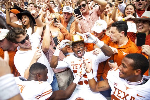 (Nick Wagner/Austin American-Statesman via AP). Texas defensive back Josh Thompson (29) celebrates with fans while wearing the Golden Hat following Texas' 48-45 win over Oklahoma in an NCAA college football game at the Cotton Bowl, Saturday, Oct. 6, 20... (Nick Wagner/Austin American-Statesman via AP). Texas defensive back Josh Thompson (29) celebrates with fans while wearing the Golden Hat following Texas' 48-45 win over Oklahoma in an NCAA college football game at the Cotton Bowl, Saturday, Oct. 6, 20...
