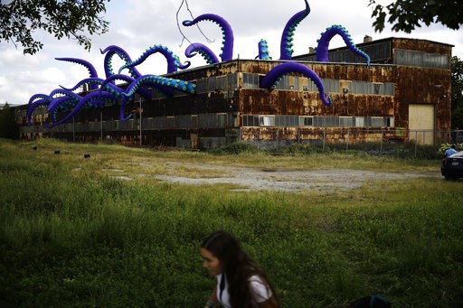 Inflatable sea monster takes over a rusting warehouse