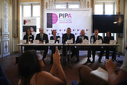 (AP Photo/Francois Mori). Lawyer Olivier Aumaitre, center, representing thousands of women with the PIP implants, speaks during a press conference in Paris, Wednesday, Oct.10, 2018. France's top court is ruling Wednesday in a case that may require some...