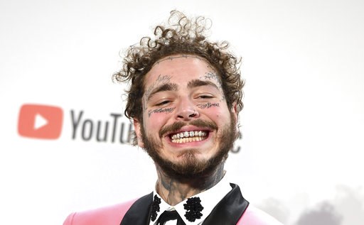 (Photo by Jordan Strauss/Invision/AP). Post Malone poses in the press room with the awards for favorite male pop/rock artist and favorite rap/hiphop album for "Beerbongs & Bentleys" in the press room at the American Music Awards on Tuesday, Oct. 9,... (Photo by Jordan Strauss/Invision/AP). Post Malone poses in the press room with the awards for favorite male pop/rock artist and favorite rap/hiphop album for "Beerbongs & Bentleys" in the press room at the American Music Awards on Tuesday, Oct. 9,...