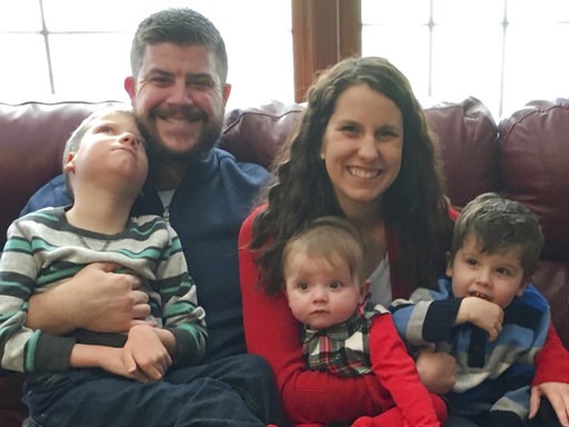 (Kilquist Family via AP). In this Dec. 10, 2017 photo provided by the family, Jon and Kari Kilquist sit with their children, from left, Will, Emmy and Owen at their home in Murphysboro, Ill. Will was born with a long list of mysterious symptoms that re...