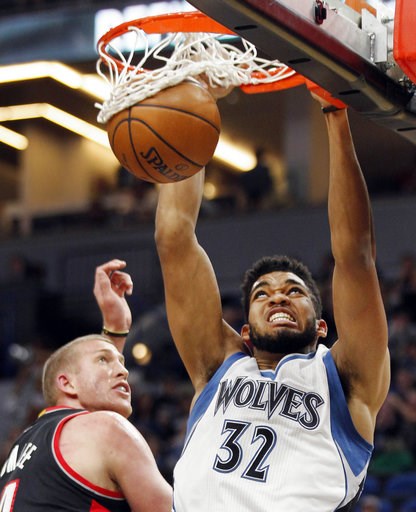 (AP Photo/Andy Clayton-King, File). FILE - In this Jan. 1, 2017, file photo, Minnesota Timberwolves forward Karl-Anthony Towns (32) dunks in front of Portland Trail Blazers forward Mason Plumlee during the first quarter of an NBA basketball game, in Mi... (AP Photo/Andy Clayton-King, File). FILE - In this Jan. 1, 2017, file photo, Minnesota Timberwolves forward Karl-Anthony Towns (32) dunks in front of Portland Trail Blazers forward Mason Plumlee during the first quarter of an NBA basketball game, in Mi...