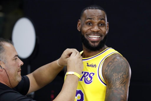 (AP Photo/Marcio Jose Sanchez, File). FILE - In this Monday, Sept. 24, 2018, file photo, Los Angeles Lakers' LeBron James smiles as a microphone is placed on his chest during media day at the NBA basketball team's practice facility in El Segundo, Calif... (AP Photo/Marcio Jose Sanchez, File). FILE - In this Monday, Sept. 24, 2018, file photo, Los Angeles Lakers' LeBron James smiles as a microphone is placed on his chest during media day at the NBA basketball team's practice facility in El Segundo, Calif...
