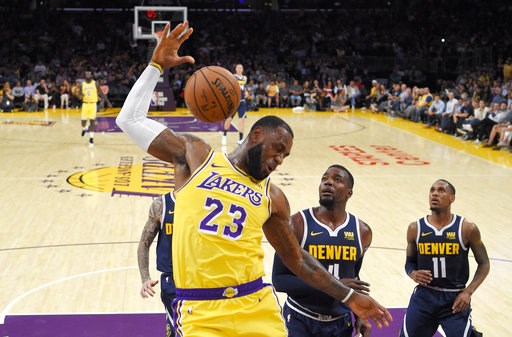 (AP Photo/Mark J. Terrill, File). FILE - In this Tuesday, Oct. 2, 2018, file photo, Los Angeles Lakers forward LeBron James, left, dunks as Denver Nuggets forward Paul Millsap, center, and guard Monte Morris watch during the first half of an NBA basket... (AP Photo/Mark J. Terrill, File). FILE - In this Tuesday, Oct. 2, 2018, file photo, Los Angeles Lakers forward LeBron James, left, dunks as Denver Nuggets forward Paul Millsap, center, and guard Monte Morris watch during the first half of an NBA basket...