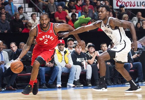 (Graham Hughes/The Canadian Press via AP). Toronto Raptors' Kawhi Leonard (2) drives to the basket as Brooklyn Nets' Treveon Graham defends during the first half of an NBA basketball preseason game Wednesday, Oct, 10, 2018, in Montreal. (Graham Hughes/The Canadian Press via AP). Toronto Raptors' Kawhi Leonard (2) drives to the basket as Brooklyn Nets' Treveon Graham defends during the first half of an NBA basketball preseason game Wednesday, Oct, 10, 2018, in Montreal.