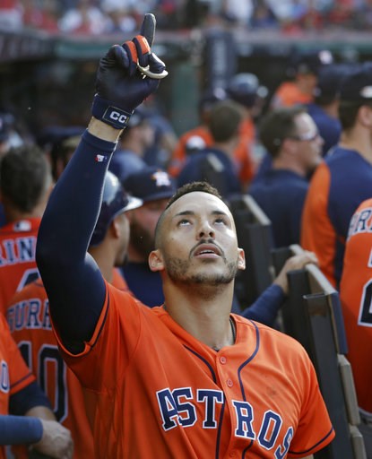 (AP Photo/David Dermer). Houston Astros' Carlos Correa celebrates in the dugout after hitting a three-run home run in the eighth inning during Game 3 of a baseball American League Division Series against the Cleveland Indians, Monday, Oct. 8, 2018, in ... (AP Photo/David Dermer). Houston Astros' Carlos Correa celebrates in the dugout after hitting a three-run home run in the eighth inning during Game 3 of a baseball American League Division Series against the Cleveland Indians, Monday, Oct. 8, 2018, in ...