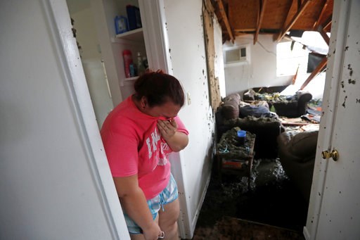 (AP Photo/Gerald Herbert). Kaylee O'Brian weeps inside her home after several trees fell on it during Hurricane Michael in Panama City, Fla., Wednesday, Oct. 10, 2018. (AP Photo/Gerald Herbert). Kaylee O'Brian weeps inside her home after several trees fell on it during Hurricane Michael in Panama City, Fla., Wednesday, Oct. 10, 2018.