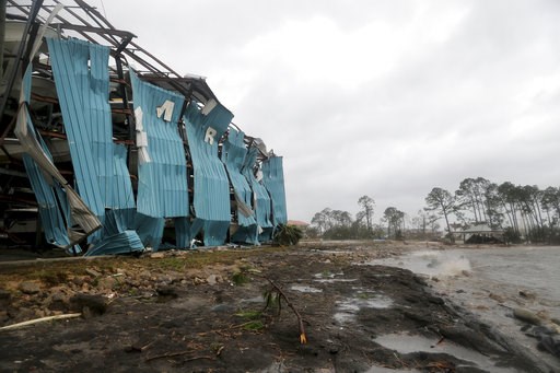 (Douglas R. Clifford/Tampa Bay Times via AP). A marina warehouse is damaged at the Port St. Joe Marina, Wednesday, Oct. 10, 2018 in Port St. Joe, Fla. Supercharged by abnormally warm waters in the Gulf of Mexico, Hurricane Michael slammed into the Flor... (Douglas R. Clifford/Tampa Bay Times via AP). A marina warehouse is damaged at the Port St. Joe Marina, Wednesday, Oct. 10, 2018 in Port St. Joe, Fla. Supercharged by abnormally warm waters in the Gulf of Mexico, Hurricane Michael slammed into the Flor...