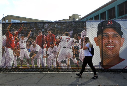 (AP Photo/Elise Amendola). A woman walks by large photo scrims hanging outside Fenway Park showing Boston Red Sox players and manager Alex Cora, Wednesday, Oct. 10, 2018, in Boston. Game 1 of the baseball American League Championship Series between the... (AP Photo/Elise Amendola). A woman walks by large photo scrims hanging outside Fenway Park showing Boston Red Sox players and manager Alex Cora, Wednesday, Oct. 10, 2018, in Boston. Game 1 of the baseball American League Championship Series between the...