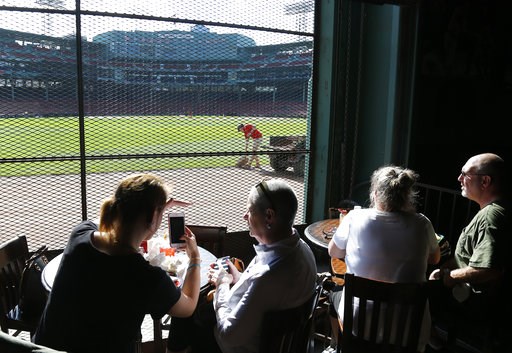 (AP Photo/Elise Amendola). Patrons inside the Bleacher Bar enjoy the view of Fenway Park, in Boston, Wednesday, Oct. 10, 2018, as grounds crew get the field ready for Game 1 of the baseball American League Championship Series between the Boston Red Sox... (AP Photo/Elise Amendola). Patrons inside the Bleacher Bar enjoy the view of Fenway Park, in Boston, Wednesday, Oct. 10, 2018, as grounds crew get the field ready for Game 1 of the baseball American League Championship Series between the Boston Red Sox...