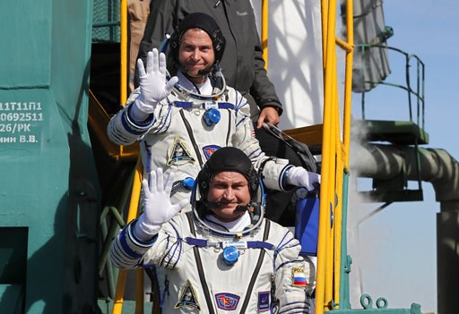 (Yuri Kochetkov, Pool Photo via AP). U.S. astronaut Nick Hague, right, and Russian cosmonaut Alexey Ovchinin, crew members of the mission to the International Space Station wave as they board the rocket prior to the launch of Soyuz-FG rocket at the Rus... (Yuri Kochetkov, Pool Photo via AP). U.S. astronaut Nick Hague, right, and Russian cosmonaut Alexey Ovchinin, crew members of the mission to the International Space Station wave as they board the rocket prior to the launch of Soyuz-FG rocket at the Rus...