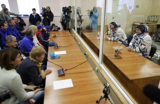 (AP Photo/Dmitri Lovetsky). U.S. astronaut Nick Hague and Russian cosmonaut Alexey Ovchinin, right, members of the main crew of the expedition to the International Space Station (ISS), speak with their relatives through a safety glass prior to the laun... (AP Photo/Dmitri Lovetsky). U.S. astronaut Nick Hague and Russian cosmonaut Alexey Ovchinin, right, members of the main crew of the expedition to the International Space Station (ISS), speak with their relatives through a safety glass prior to the laun...