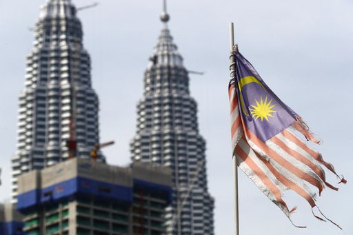 (AP Photo/Vincent Thian, File). FILE - In this April 10, 2018, a battered Malaysian national flag flies in front of the Petronas Towers in Kuala Lumpur, Malaysia. Malaysia's government says it will abolish the death penalty and halt all executions, in ... (AP Photo/Vincent Thian, File). FILE - In this April 10, 2018, a battered Malaysian national flag flies in front of the Petronas Towers in Kuala Lumpur, Malaysia. Malaysia's government says it will abolish the death penalty and halt all executions, in ...