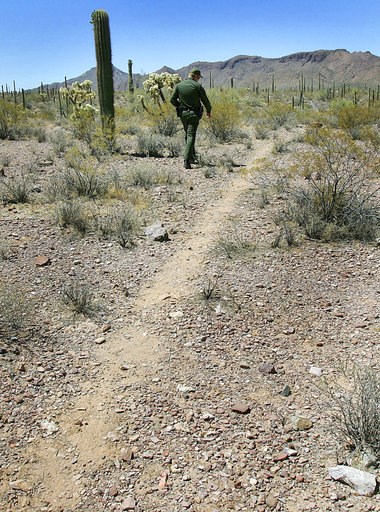 (AP Photo/Matt York). FILE - In this May 24, 2006, file photo, U.S. Border Patrol Senior Agent Sean King patrols a trail in Organ Pipe Cactus National Monument near Lukeville, Ariz. Smugglers in recent weeks have been abandoning large groups of Guatema... (AP Photo/Matt York). FILE - In this May 24, 2006, file photo, U.S. Border Patrol Senior Agent Sean King patrols a trail in Organ Pipe Cactus National Monument near Lukeville, Ariz. Smugglers in recent weeks have been abandoning large groups of Guatema...