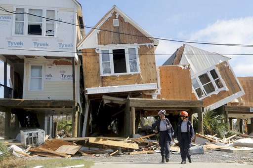 (Douglas R. Clifford/Tampa Bay Times via AP). Emergency workers Dr. Patricia Cantrell, left, and Ana Kaufmann, with the South Florida Search and Rescue Task Force 2, survey damage at the western edge of town in Mexico Beach, Fla., after Hurricane Micha... (Douglas R. Clifford/Tampa Bay Times via AP). Emergency workers Dr. Patricia Cantrell, left, and Ana Kaufmann, with the South Florida Search and Rescue Task Force 2, survey damage at the western edge of town in Mexico Beach, Fla., after Hurricane Micha...