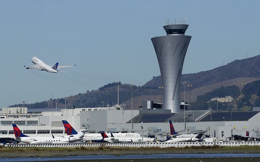 (AP Photo/Jeff Chiu, File). FILE - In this Oct. 24, 2107 file photo, the air traffic control tower is in sight as a plane takes off from San Francisco International Airport in San Francisco. Aviation-safety officials say a close call last year highligh... (AP Photo/Jeff Chiu, File). FILE - In this Oct. 24, 2107 file photo, the air traffic control tower is in sight as a plane takes off from San Francisco International Airport in San Francisco. Aviation-safety officials say a close call last year highligh...