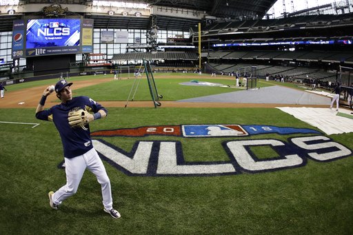 (AP Photo/Matt Slocum). Milwaukee Brewers' Christian Yelich warms up for practice for Game 1 of the National League Championship Series baseball game Los Angeles Dodgers Thursday, Oct. 11, 2018, in Milwaukee. (AP Photo/Matt Slocum). Milwaukee Brewers' Christian Yelich warms up for practice for Game 1 of the National League Championship Series baseball game Los Angeles Dodgers Thursday, Oct. 11, 2018, in Milwaukee.